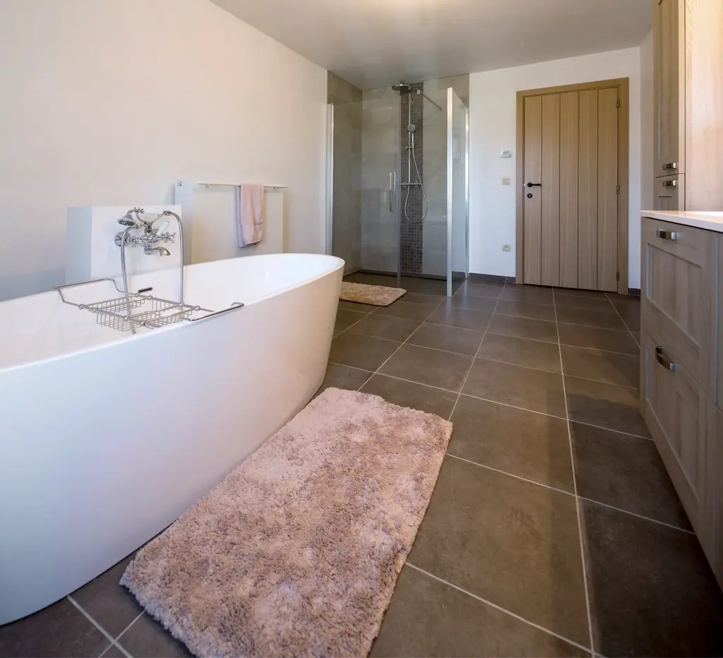 Renovated bathroom with a freestanding bathtub and wooden floor
